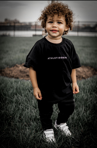 a child model wearing Athletisqueak black tshirt